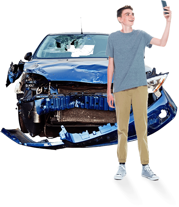 Young driver taking a selfie in front of a vehicle that has been in an accident.